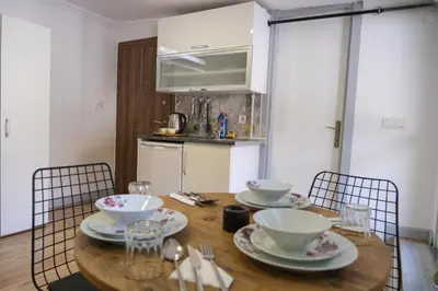a dining room table with bowls and plates on it at Taksim Neo Pera Suites in Istanbul