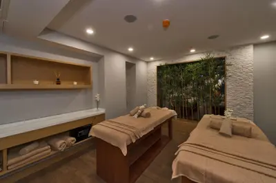 a massage room with two beds and a window at Hotel Boursier 1 & Spa in Istanbul