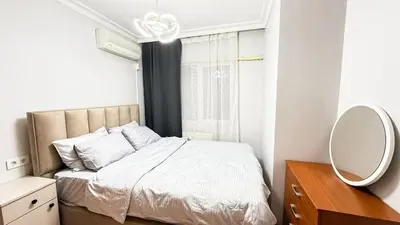 a small bedroom with a bed and a mirror at Bomenti Sisli in Istanbul
