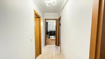 a hallway leading to a living room with a ceiling at Bomenti Sisli in Istanbul
