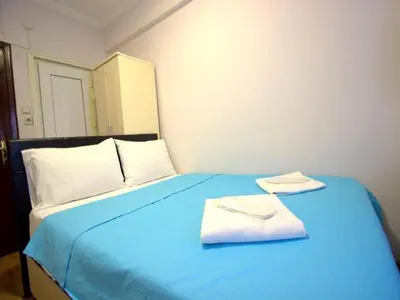 a blue bed with two towels on top of it at SİMGE SULTAN' old cty in Istanbul