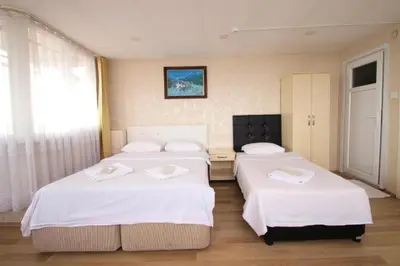a bedroom with two beds with white sheets at SİMGE SULTAN' old cty in Istanbul