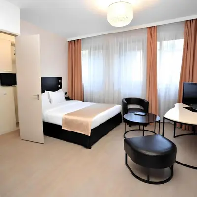 a hotel room with a bed and tables and chairs at SİMGE SULTAN' old cty in Istanbul