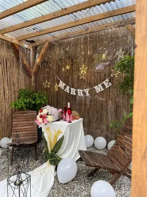 a table with two chairs and a happy birthday banner at Rcsapanca in Sapanca