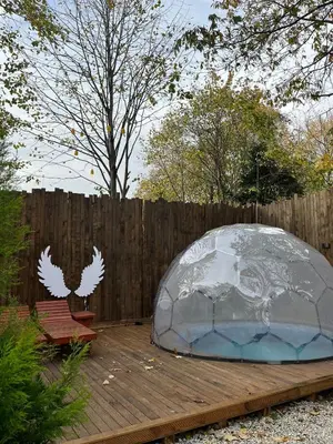 a dome tent on a wooden deck with a fence at Wolf house in Sapanca