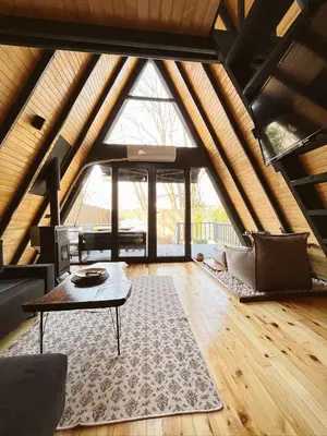 a living room with a table and a large window at Wolf house in Sapanca