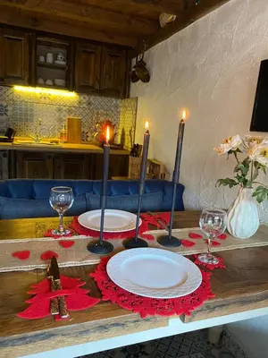 a table with two plates and two candles on it at Aknadağevi sapanca in Sapanca