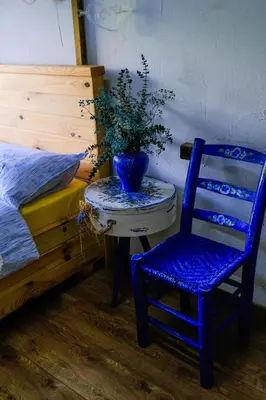 a blue chair sitting next to a table with a plant on it at Aknadağevi sapanca in Sapanca