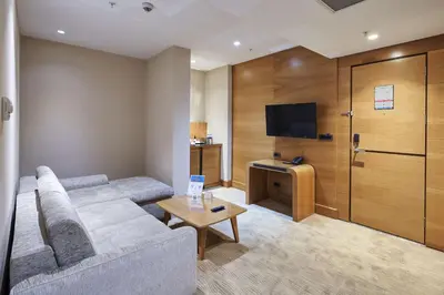 a living room with a couch and a flat screen tv at DoubleTree by Hilton Hotel Istanbul - Tuzla in Istanbul