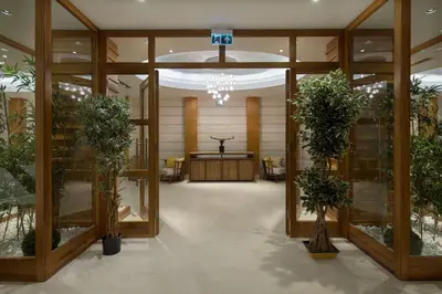 a lobby with glass doors and plants in a building at DoubleTree by Hilton Hotel Istanbul - Tuzla in Istanbul