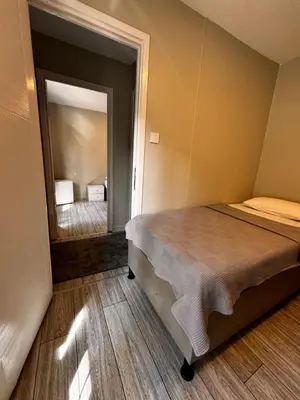 a bedroom with a bed and a mirror at Ali Baba Butik Otel in Gündoğdu