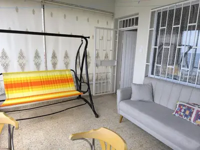 a living room with a swing and a couch at Villa Taskoparan in Tekirdag