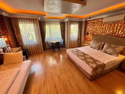 a bedroom with a bed and a table and chairs at Meydan Suites in Istanbul
