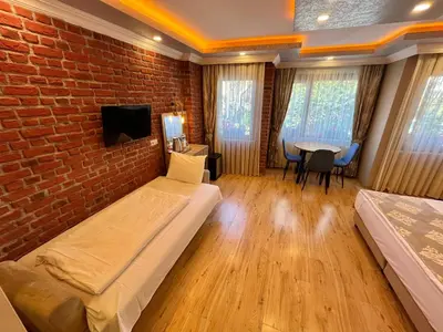 a room with two beds and a brick wall at Meydan Suites in Istanbul