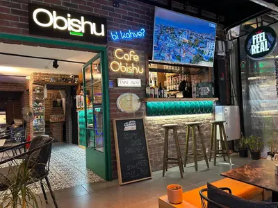 a restaurant with a bar with stools in front of it at Obishu in Istanbul
