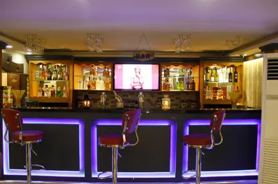a bar with purple lighting in a bar with stools at Marmara Place Old City Hotel in Istanbul