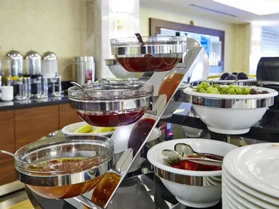 a buffet with bowls of different types of food at Marmara Place Old City Hotel in Istanbul