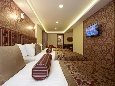 a hotel room with two beds and a tv at Marmara Place Old City Hotel in Istanbul