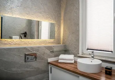 a bathroom with a sink and a mirror at 216 Silver Suite in Tuzla