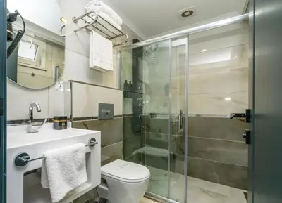 a bathroom with a shower and a toilet and a sink at 216 Silver Suite in Tuzla