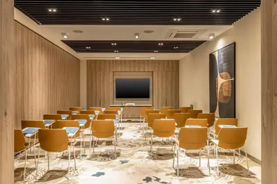 a conference room with chairs and a projection screen at GOLDEN TULIP GEBKIM KOCAELI in Kocaeli