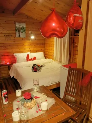 a bedroom with a bed and a table and lanterns at Çakıl Restoran ve Bungolov in Silivri