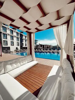 a balcony with a couch and a swimming pool at Bohem Hotel in Beykoz