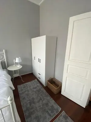 a bedroom with a white door and a bed and a table at DESTA Turizm in Istanbul