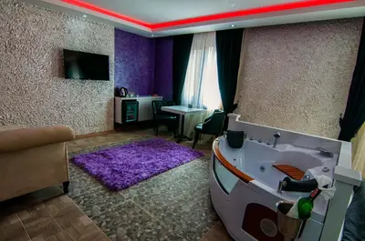 a living room with a purple room with a tub at AG Hotel & Residence Şişli in Istanbul