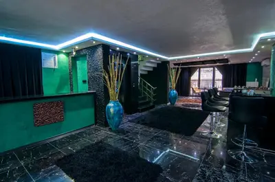 a lobby with two blue vases and a bar at AG Hotel & Residence Şişli in Istanbul