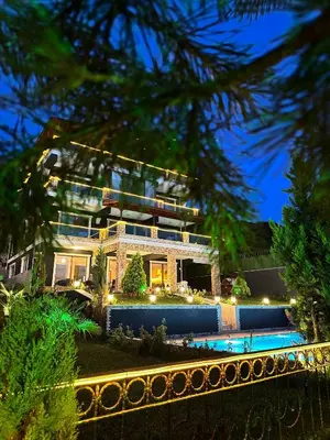 a building with a pool in front of it at Montana butik pansiyon in Sapanca