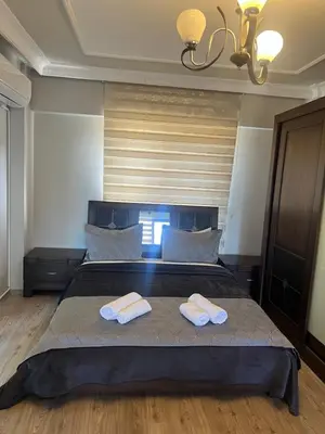 a bedroom with a bed with two towels on it at Montana butik pansiyon in Sapanca