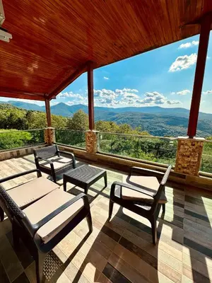 a screened in porch with a view of the mountains at Montana butik pansiyon in Sapanca