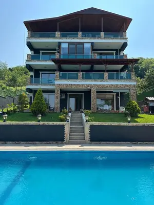 a house with a swimming pool in front of it at Montana butik pansiyon in Sapanca