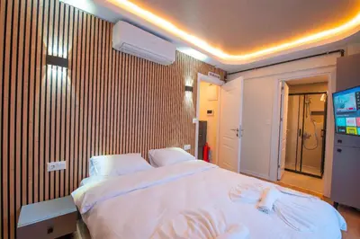 a bedroom with a large bed and a television at Mar Residence in Istanbul