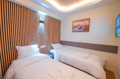 a hotel room with two beds and a window at Mar Residence in Istanbul