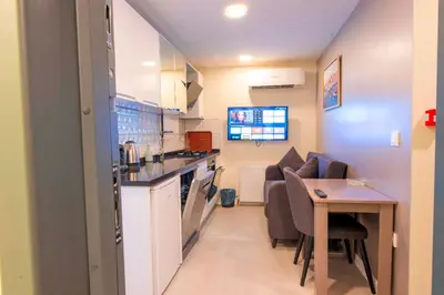 a small kitchen and dining room with a table and chairs at Mar Residence in Istanbul