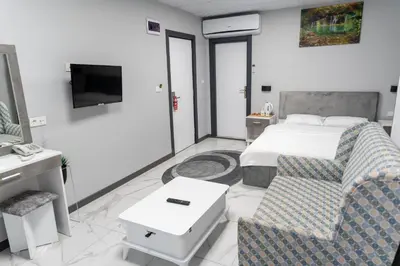 a hotel room with a bed and a tv at Merkez Otel in Cerkezkoy