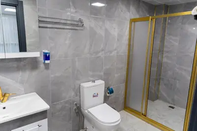a bathroom with a toilet and a shower and a sink at Merkez Otel in Cerkezkoy