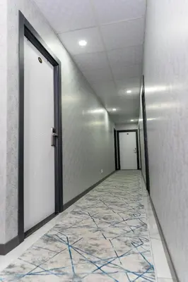an empty hallway with a door and a tile floor at Merkez Otel in Cerkezkoy