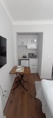 a small kitchen with a table in a room at Studios & Balat in Istanbul