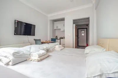 a large white bedroom with white pillows on a bed at Studios & Balat in Istanbul
