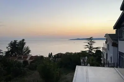 a view of the ocean at sunset from a house at Villa 7even By Luxury Group in Buyukcekmece