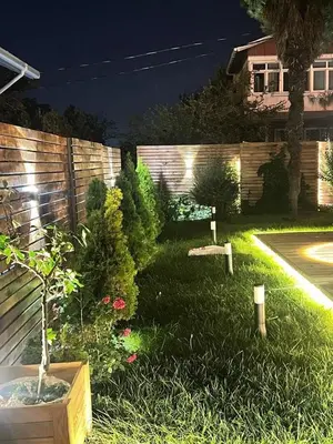 a garden with plants and a fence at night at Villa 7even By Luxury Group in Buyukcekmece