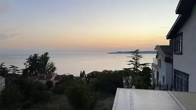 a view of the ocean at sunset from a house at Villa 7even By Luxury Group in Buyukcekmece