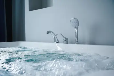a bath tub filled with water next to a faucet at Elite World Homes Istanbul Bosphorus in Istanbul