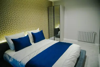 a bedroom with a large bed with blue pillows at Elite World Homes Istanbul Bosphorus in Istanbul
