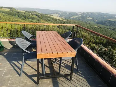a wooden table and chairs on a balcony at Nerry's Garden Izmit - Rose in Yukarı Mecidiye