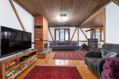 a living room with a large flat screen tv at Uludağ Tatil Evleri & Villa Seyir in Yigitali
