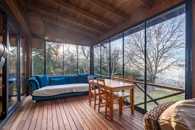 a bedroom with a couch and a table on a deck at Uludağ Tatil Evleri & Villa Seyir in Yigitali